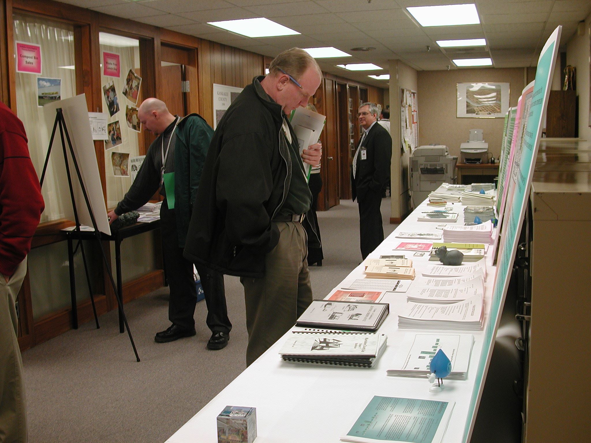 People Standing Next to Long Table
